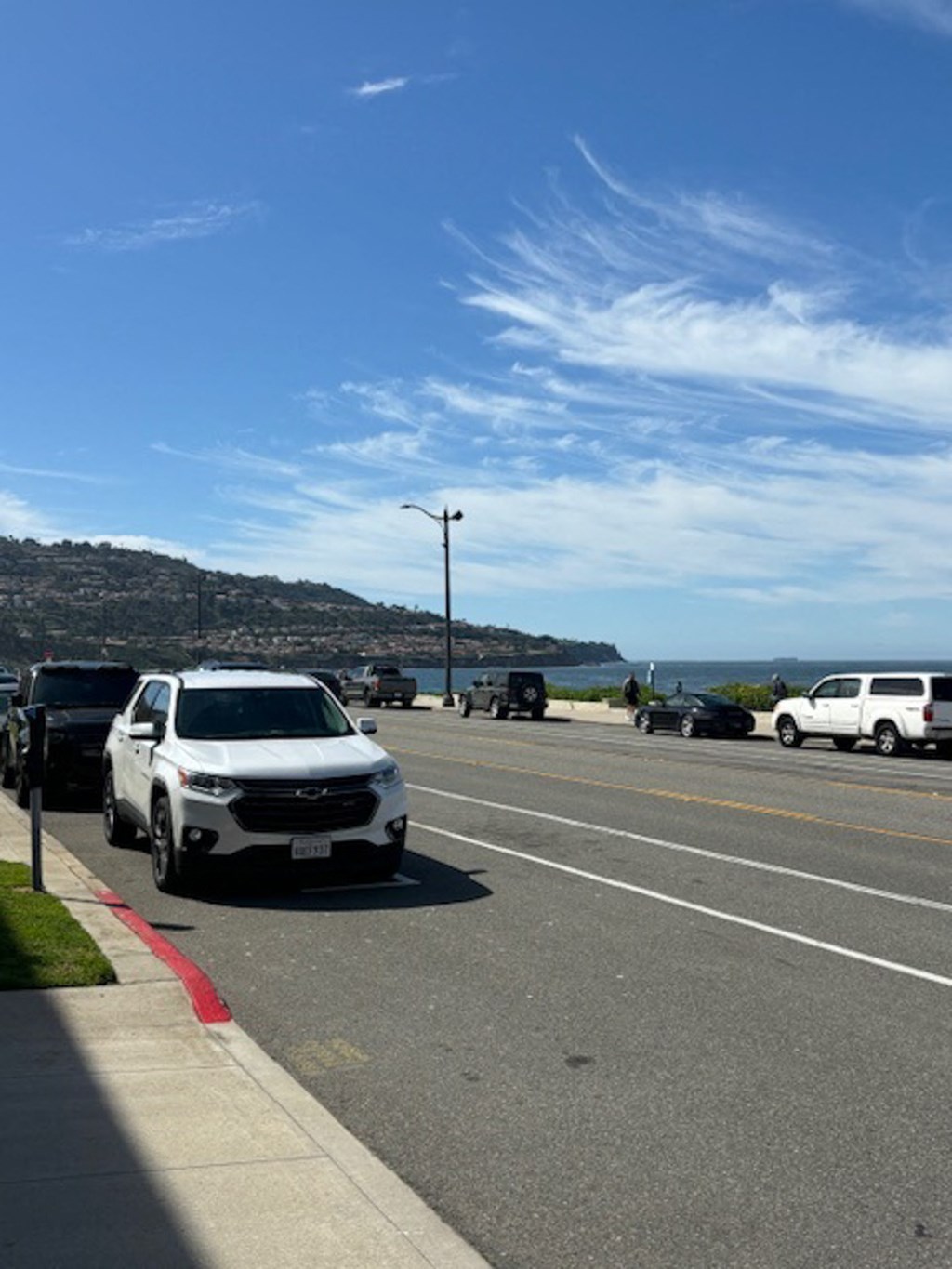 a car parked on the side of a road near the ocean