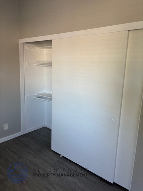 a closet with a white wall and a sink in it