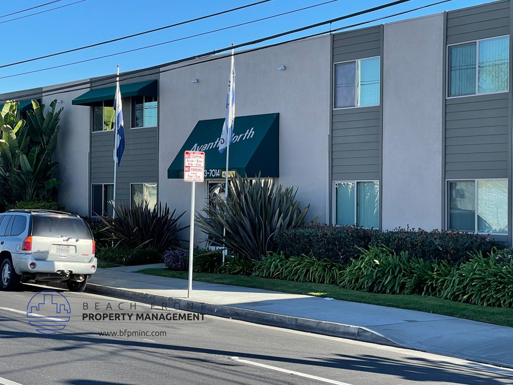 a van parked in front of a beach property management building