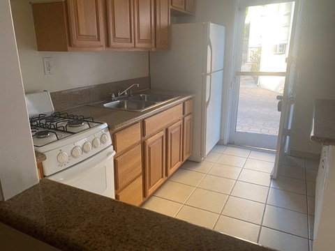 a kitchen with a stove and a sink and a refrigerator