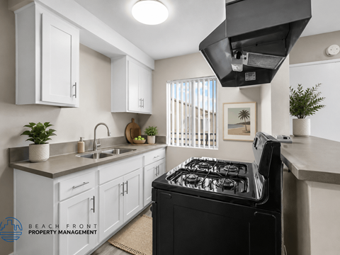 A modern kitchen with a black stove top oven.
