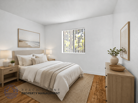 A well-lit bedroom with a large bed and a wooden cabinet.