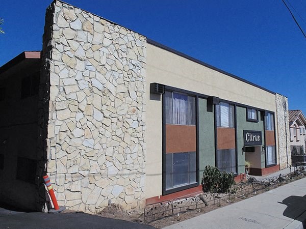 a stone building with a fire hydrant in front of it