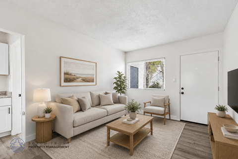 A living room with a couch, chair, and table.