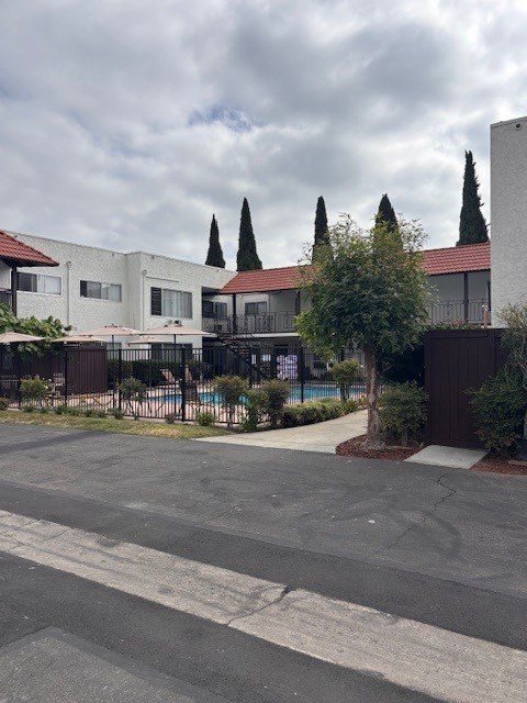 A building with a pool in front of it.