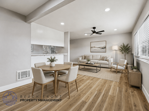 A well-lit, modern dining room with a wooden floor and a white ceiling fan.