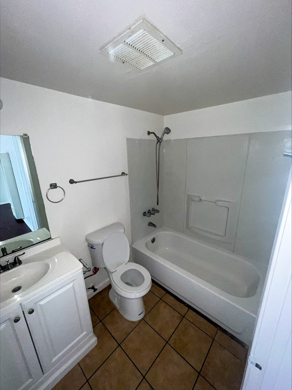 a bathroom with a toilet and a tub and a sink