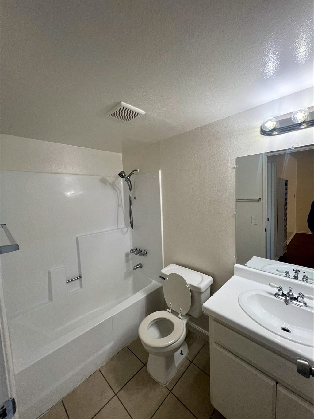 a bathroom with a toilet and a sink and a bath tub