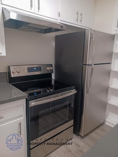 a kitchen with a stove and a refrigerator