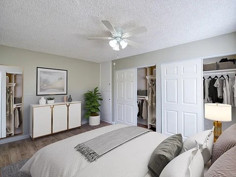 A bedroom with a bed, dresser, and closet.