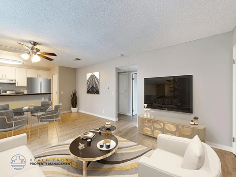 A living room with a television, a sofa, and a coffee table.