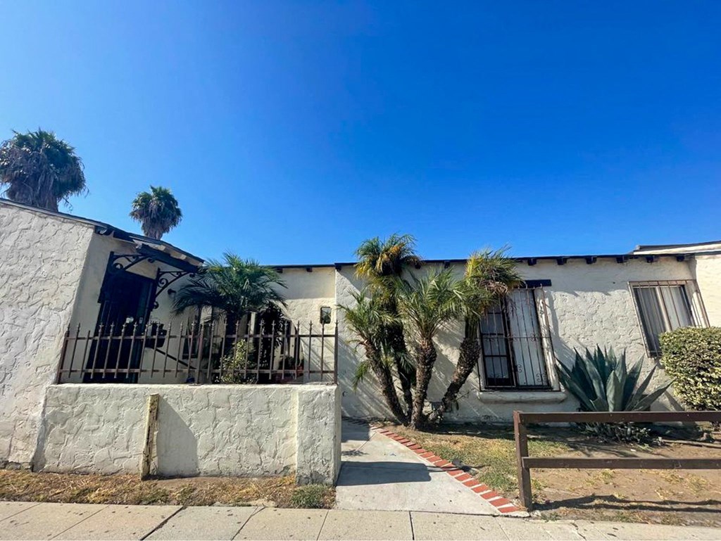 a house with palm trees in front of it