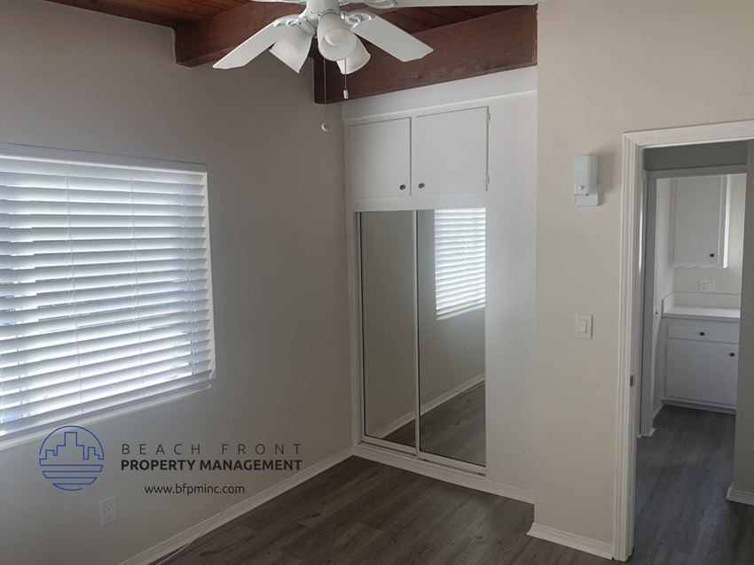 a room with a mirror and a closet