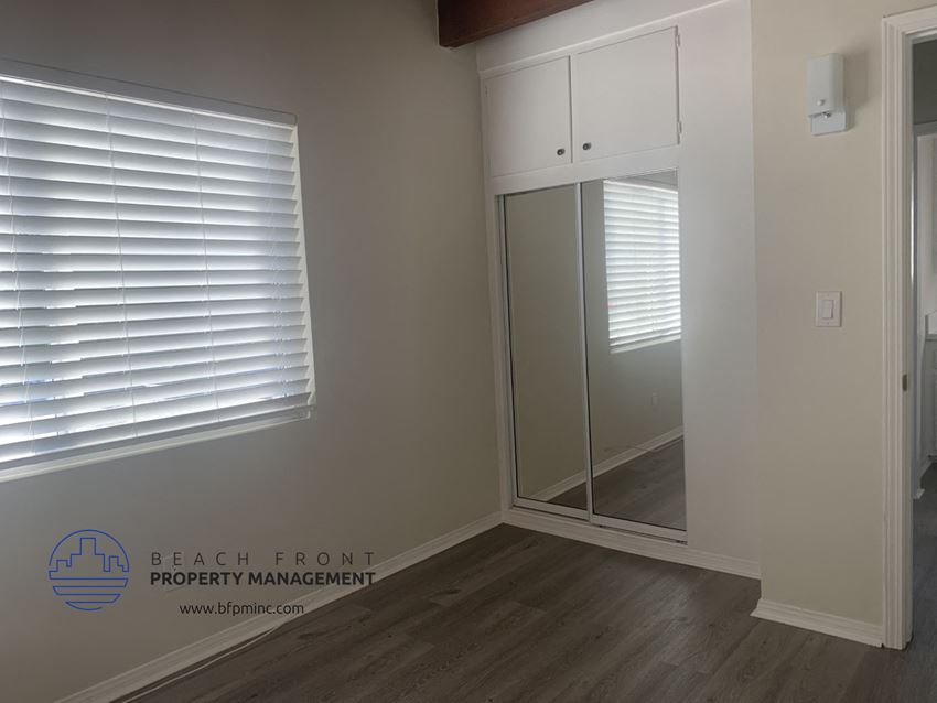 a room with a mirror and a closet