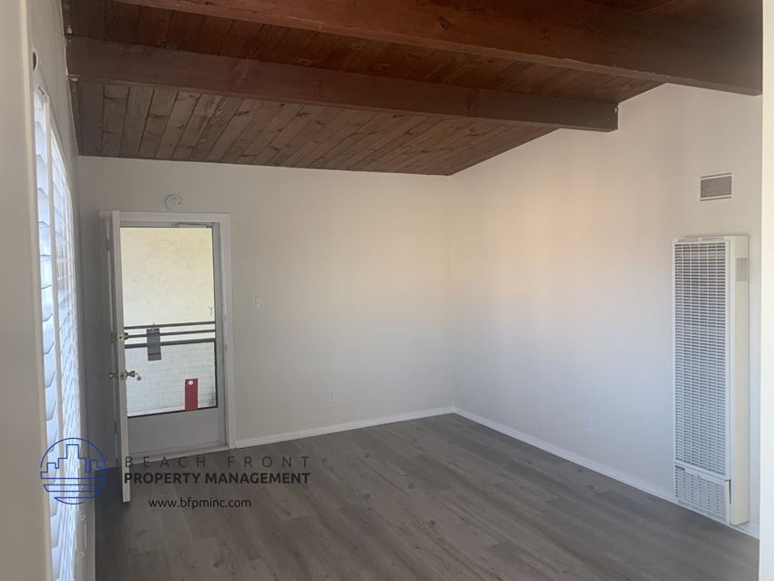 the interior of a room with white walls and a wooden ceiling