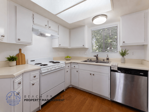 A kitchen with white cabinets and a stainless steel dishwasher.