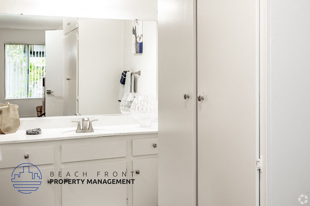 A bathroom with a sink and a mirror.
