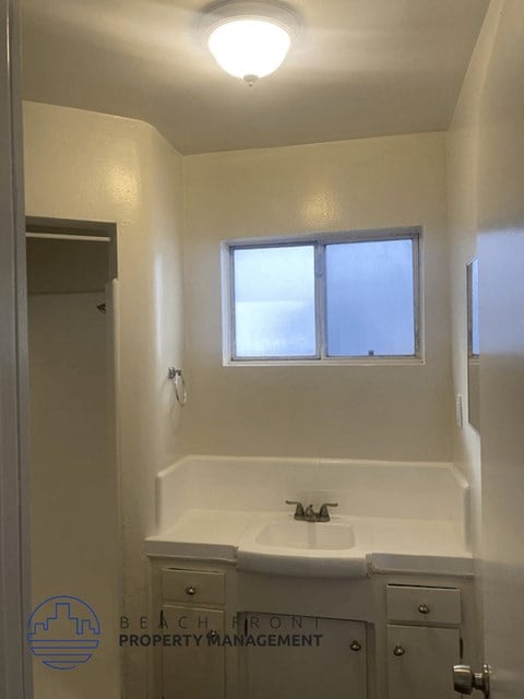a small bathroom with a sink and a window