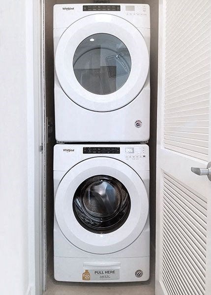 a washing machine and a dryer in a closet