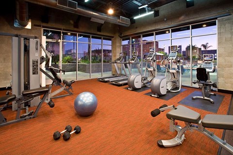 a gym with a view of the city at night