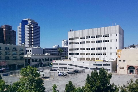a city with tall buildings and a parking lot