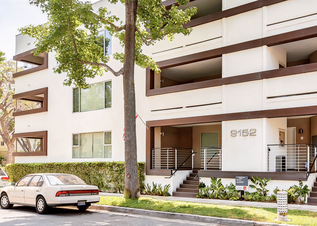a car parked in front of an apartment building