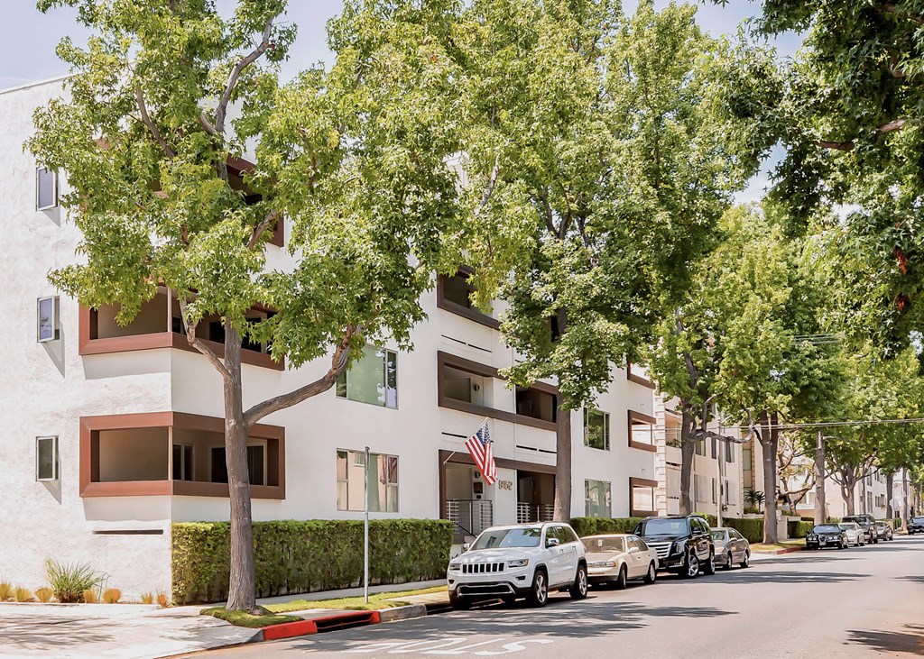 a city street with cars parked in front of a building