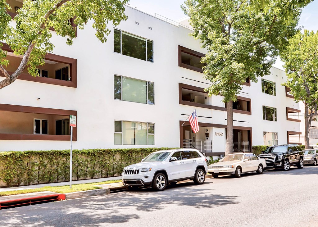 a white building with cars parked in front of it