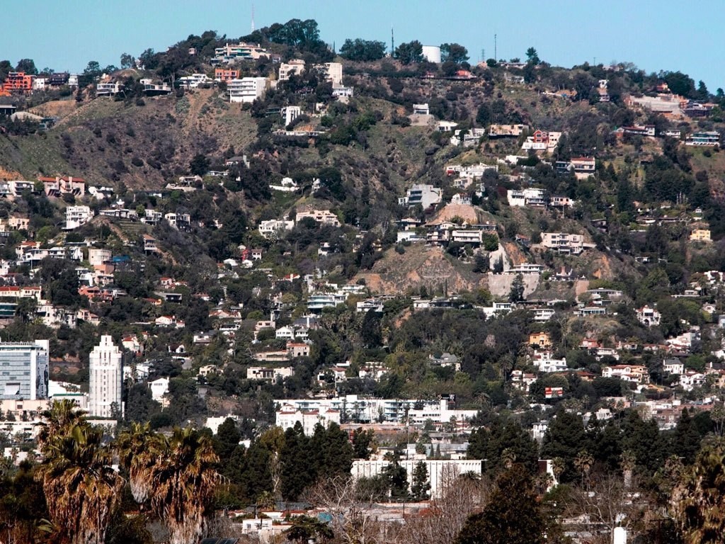 a view of a hillside filled with houses and trees