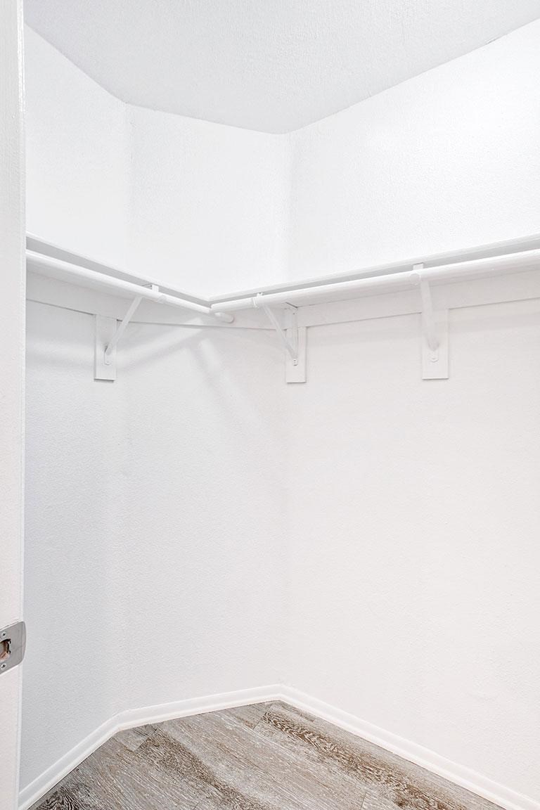 an empty room with white walls and a white closet