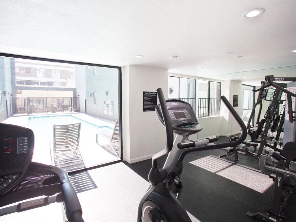 the gym is next to the pool in the building