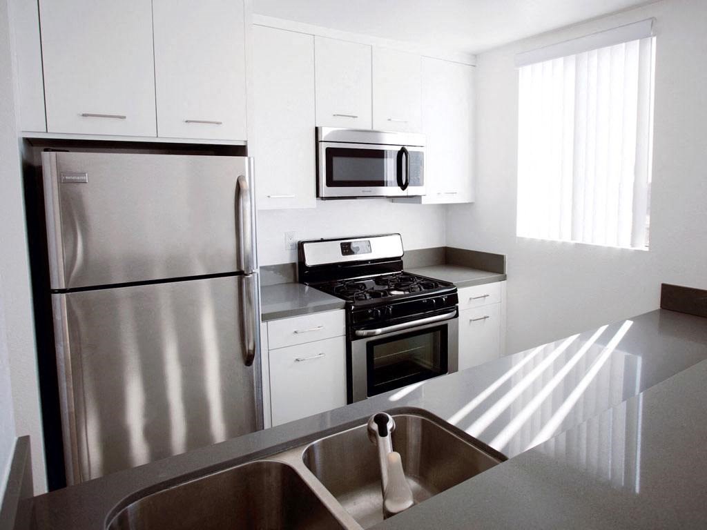 a kitchen with stainless steel appliances and white cabinets
