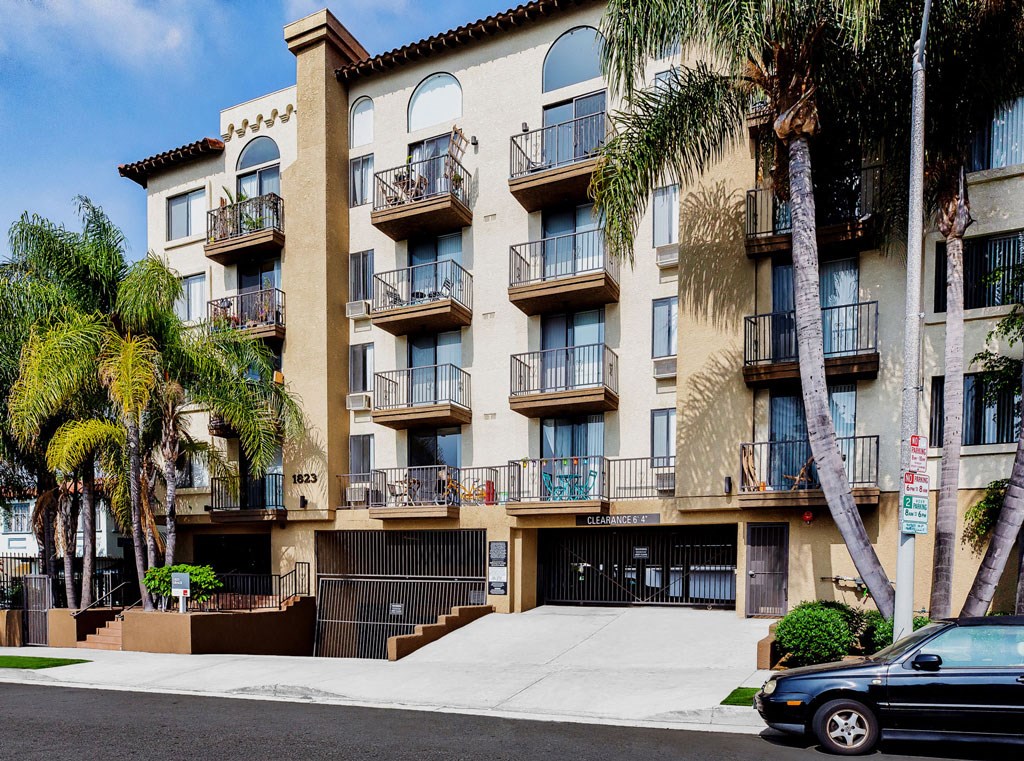 a car parked in front of an apartment building