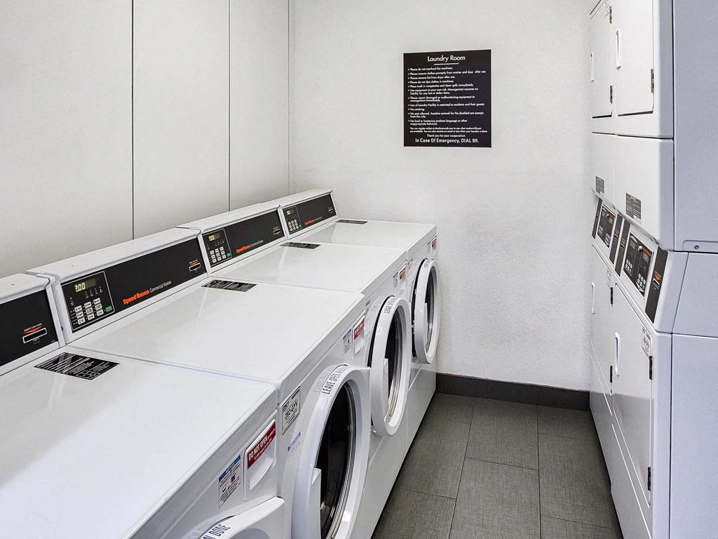 a laundry room with washing machines and dryers