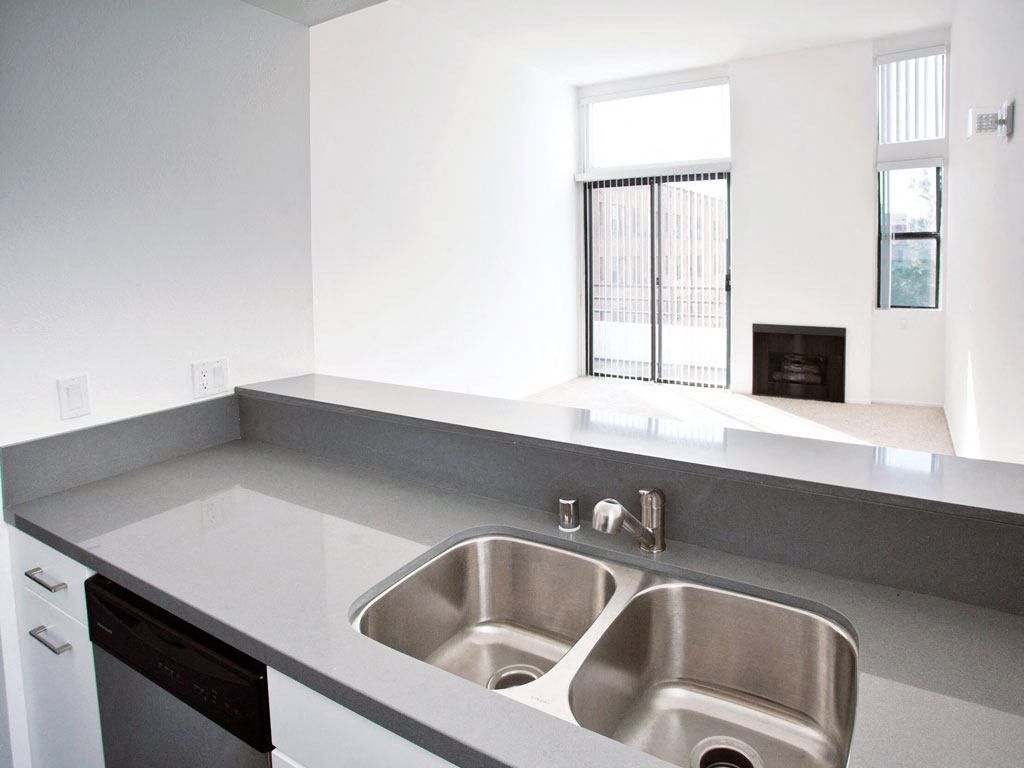 an empty kitchen with a sink and a window