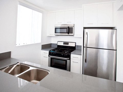 a kitchen with stainless steel appliances and a sink