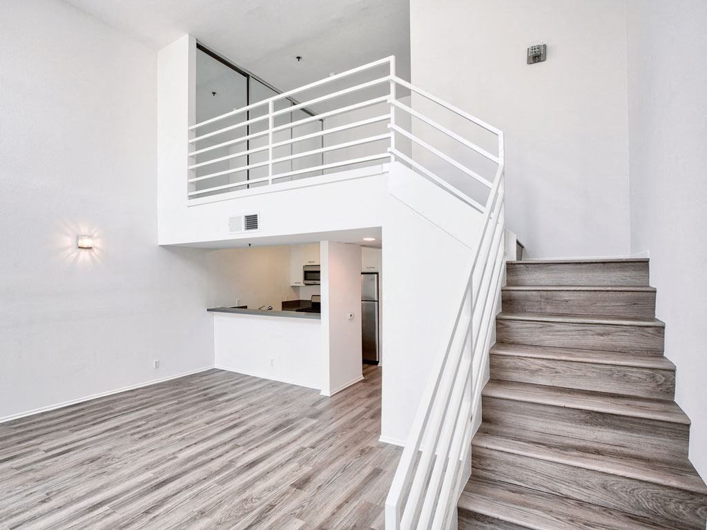 a view of a staircase in a home with wood floors and white walls