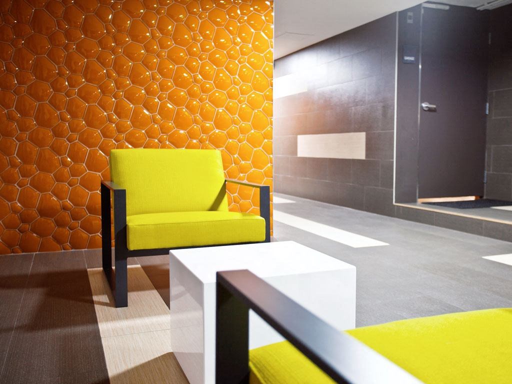 a yellow chair and a white table in a room