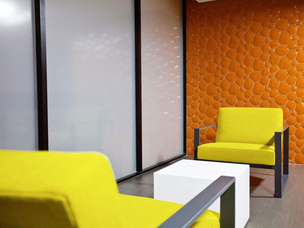 a living room with yellow chairs and a white table