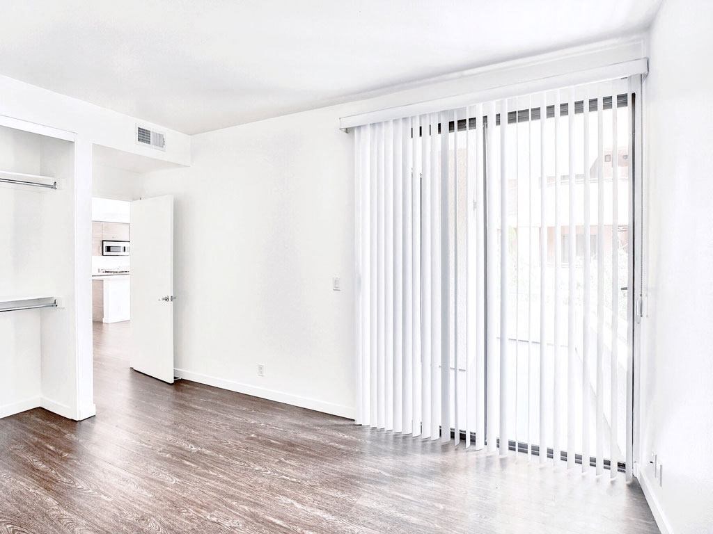 an empty living room with a sliding glass door