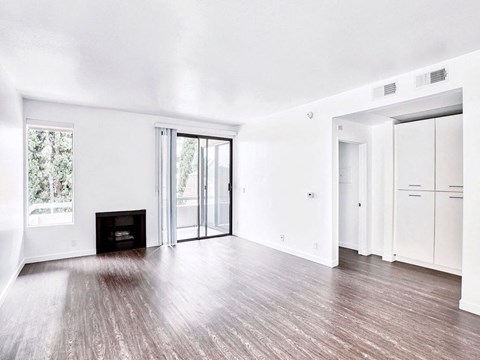 an empty living room with white walls and a fireplace