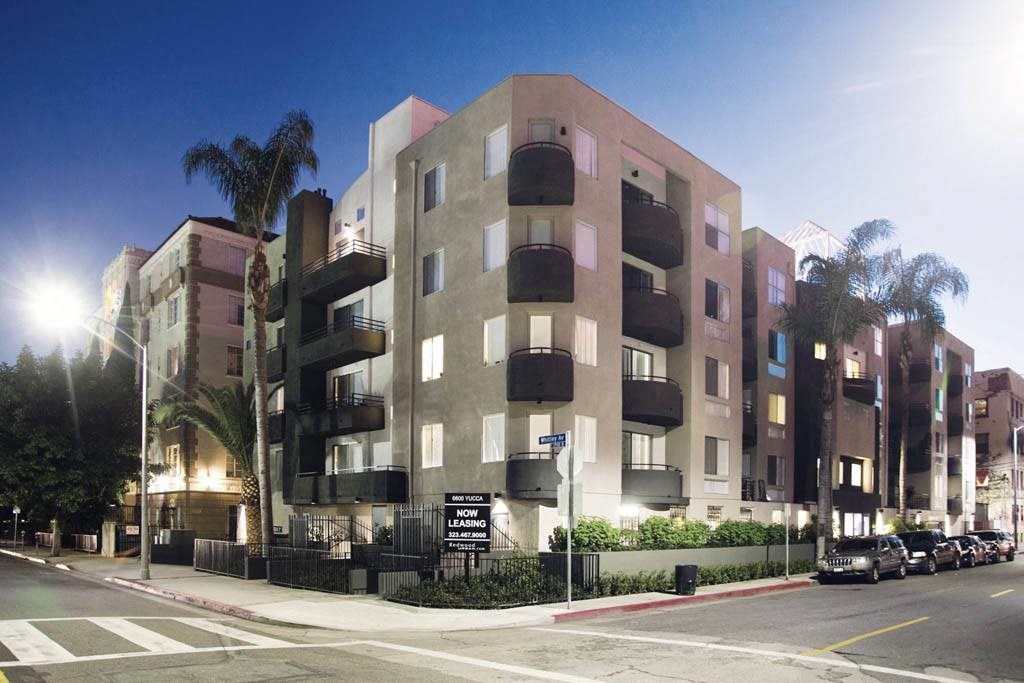 a rendering of an apartment building on a city street