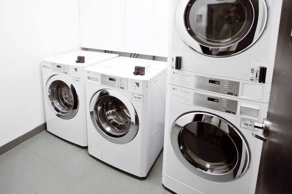 a row of washing machines in a laundry room