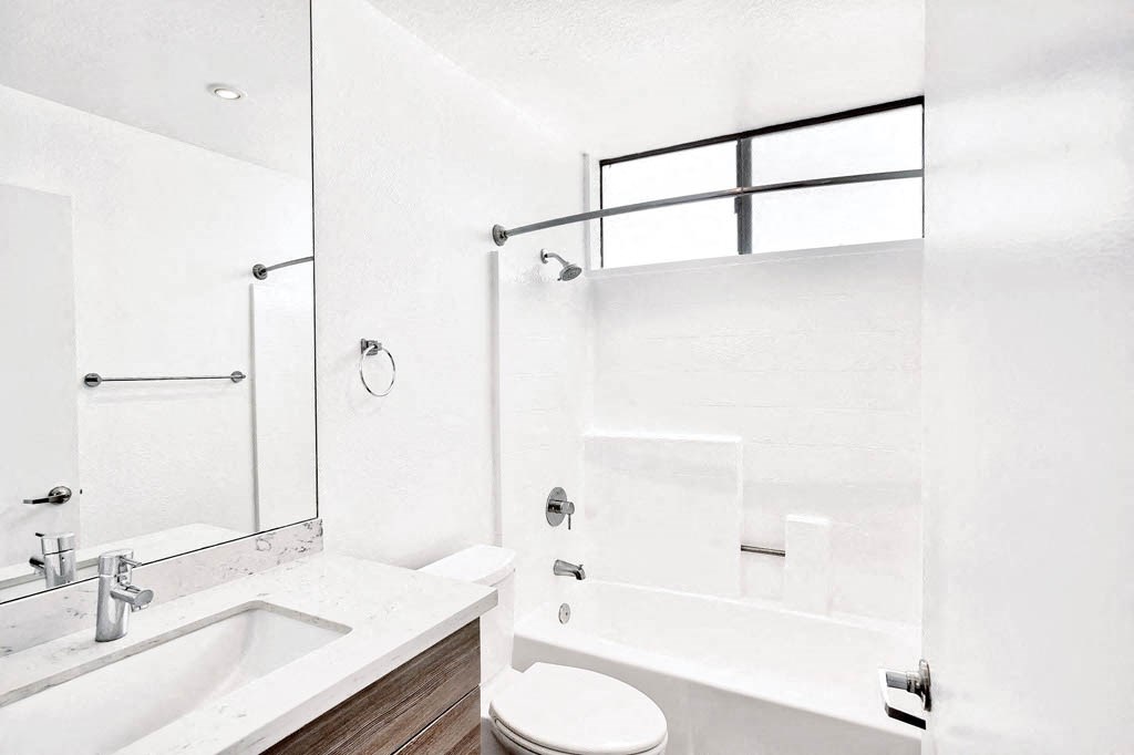 a bathroom with a sink toilet and a bath tub