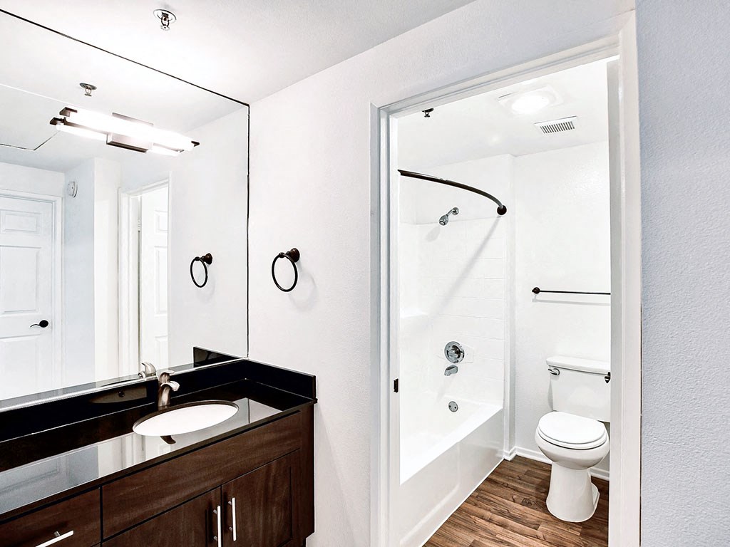 a bathroom with a toilet sink and a shower