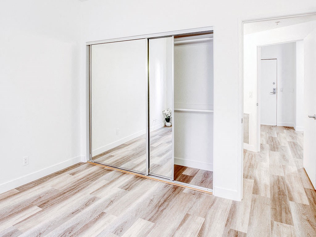 a room with white walls and sliding glass doors
