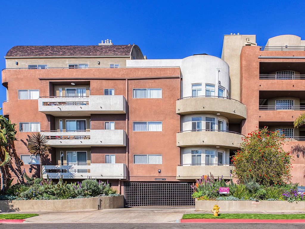 a large apartment building with balconies and a fire hydrant