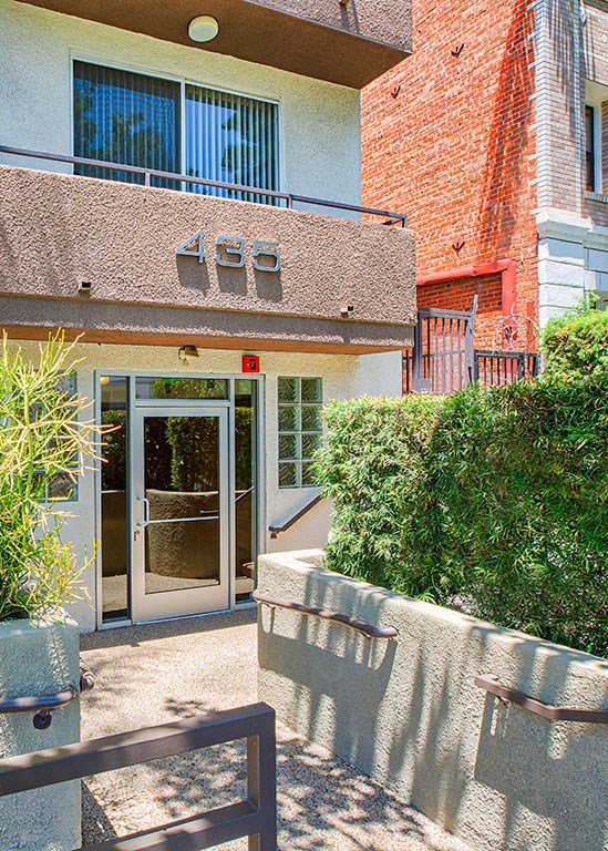the front entrance of a building with a glass door