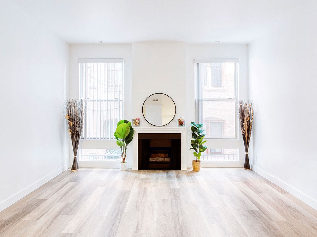 a living room with a fireplace and a mirror in it