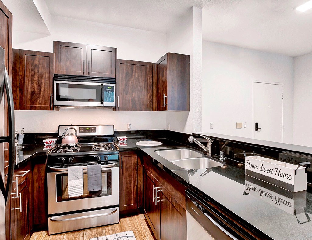 a kitchen with a stove and a sink and a microwave